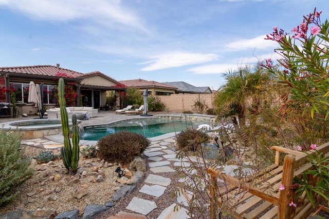 view of swimming pool with a patio area and an in ground hot tub