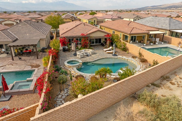 view of pool featuring an in ground hot tub and a patio