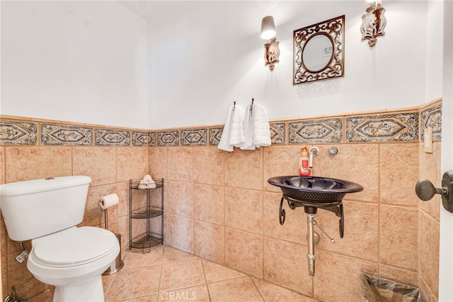 bathroom featuring tile walls, toilet, and tile patterned floors