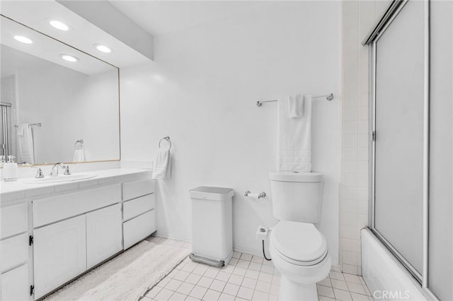 full bathroom featuring tile patterned floors, toilet, vanity, and enclosed tub / shower combo