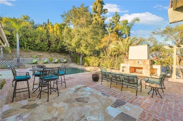 view of patio / terrace with an outdoor living space with a fireplace