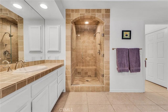 bathroom featuring tile patterned floors, vanity, and an enclosed shower