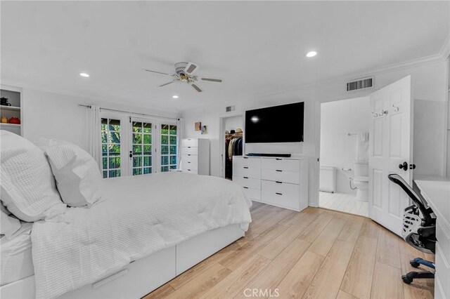 bedroom featuring french doors, a walk in closet, ensuite bath, light hardwood / wood-style floors, and a closet