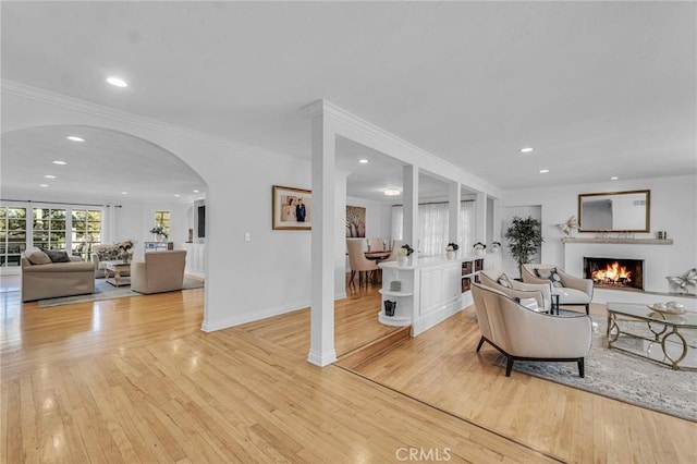 living room featuring ornamental molding and light hardwood / wood-style floors