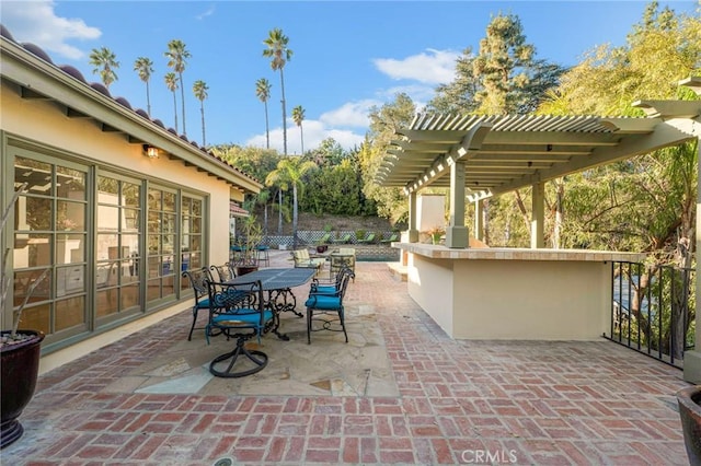 view of patio with an outdoor bar and a pergola