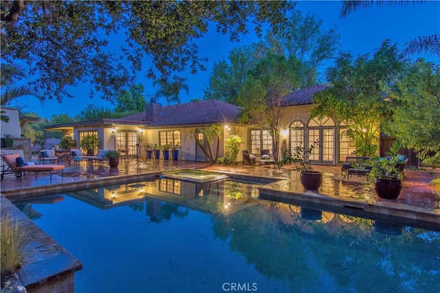 view of pool featuring french doors and a patio area