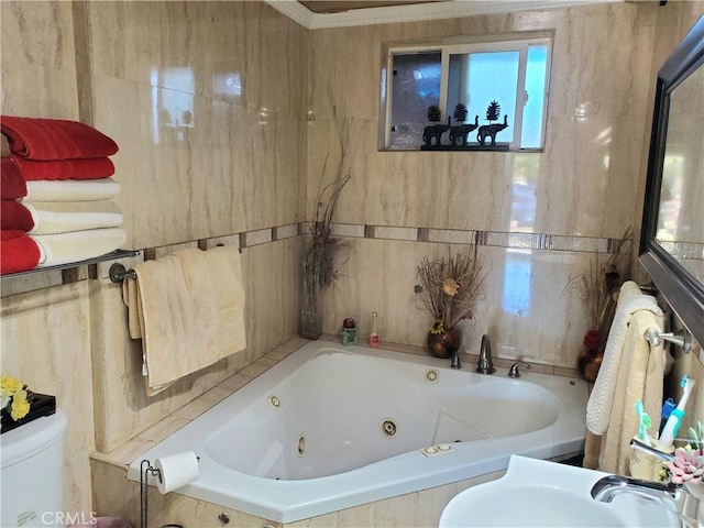 bathroom featuring sink, toilet, and tiled tub