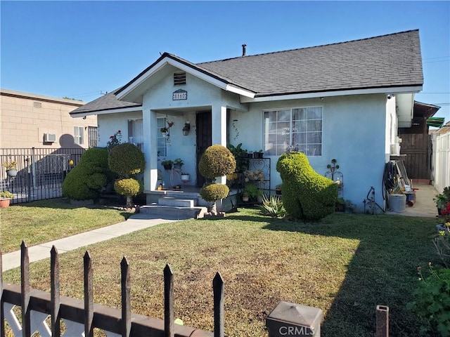 bungalow-style home with a front yard