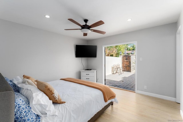 bedroom featuring ceiling fan, light hardwood / wood-style floors, and access to outside