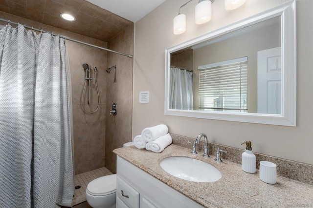 bathroom featuring toilet, vanity, and a shower with curtain