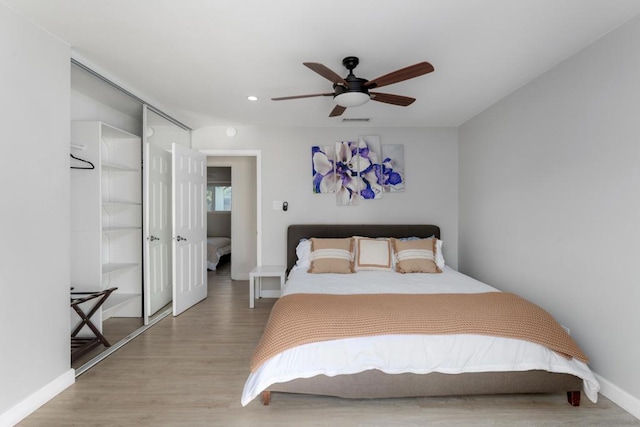 bedroom featuring a closet, ceiling fan, and wood-type flooring