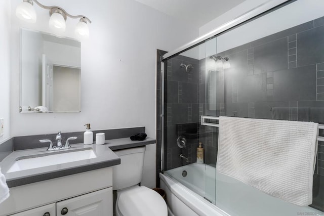 full bathroom featuring vanity, toilet, and combined bath / shower with glass door