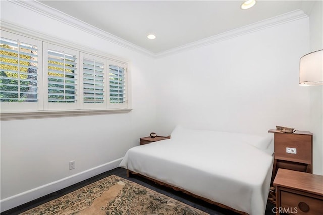 bedroom with crown molding and wood-type flooring