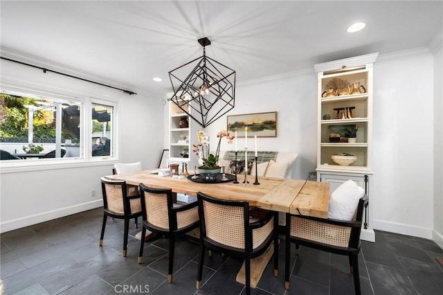 dining room featuring ornamental molding and an inviting chandelier