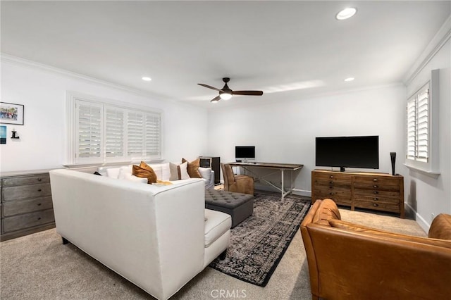 living room featuring ceiling fan, light carpet, and crown molding