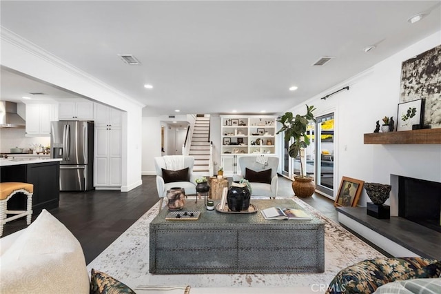 living room featuring ornamental molding and dark hardwood / wood-style flooring