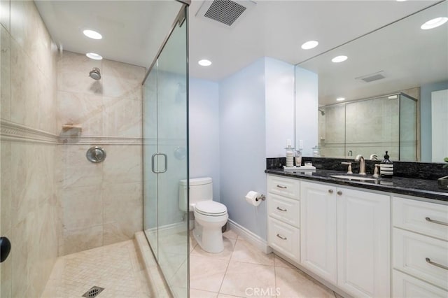 bathroom with vanity, toilet, an enclosed shower, and tile patterned flooring