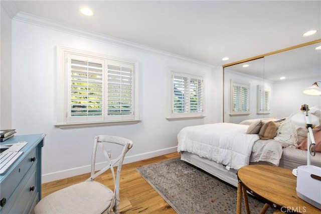 bedroom with crown molding and light hardwood / wood-style floors