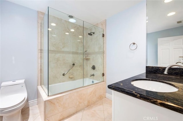 full bathroom with combined bath / shower with glass door, toilet, and vanity