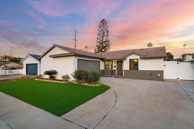 ranch-style house with a garage and a yard