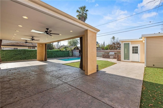 view of patio / terrace with ceiling fan and a fenced in pool