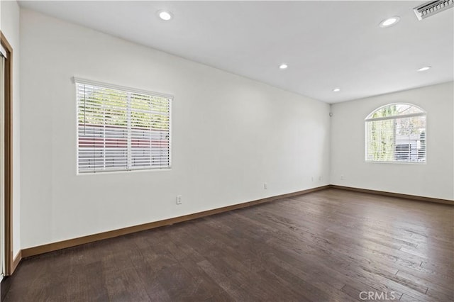 unfurnished room with dark hardwood / wood-style flooring