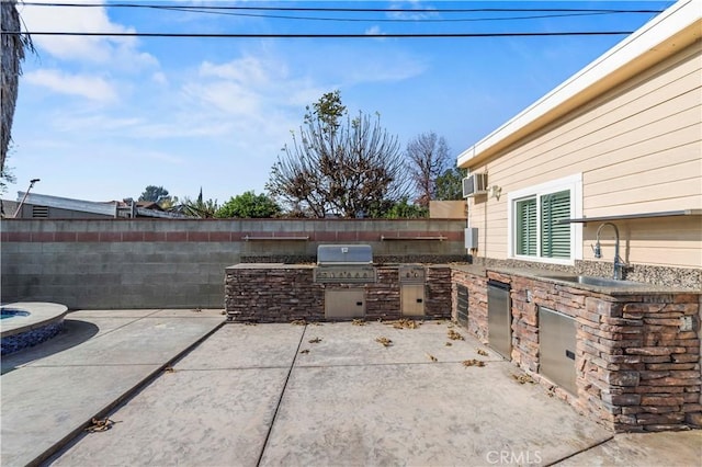 view of patio with grilling area, sink, and area for grilling