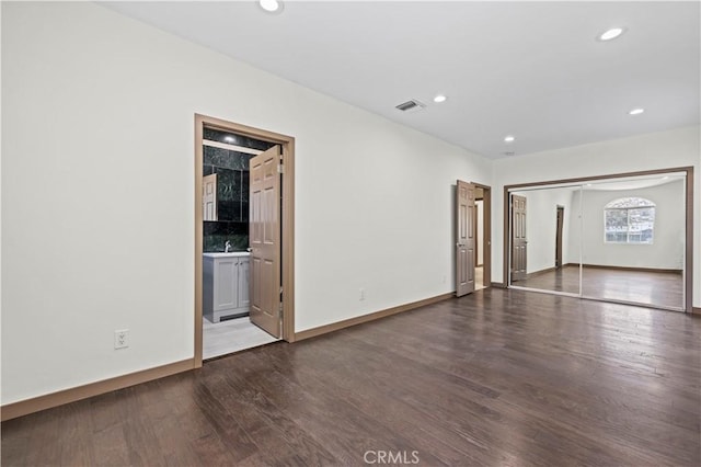 spare room featuring dark wood-type flooring