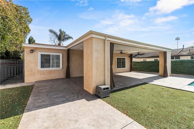 view of front of home with a patio area, a front lawn, and ceiling fan