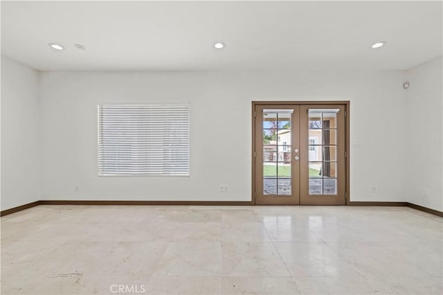 unfurnished room featuring french doors