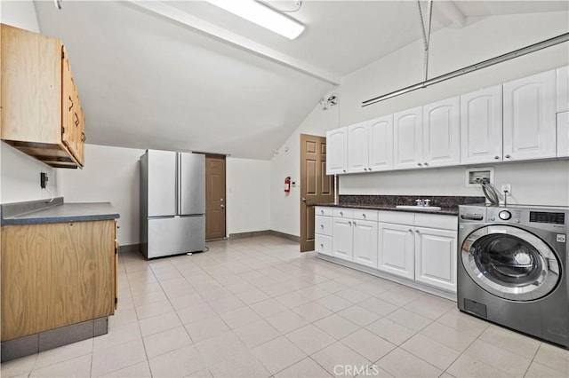 clothes washing area with sink, light tile patterned flooring, and washer / dryer