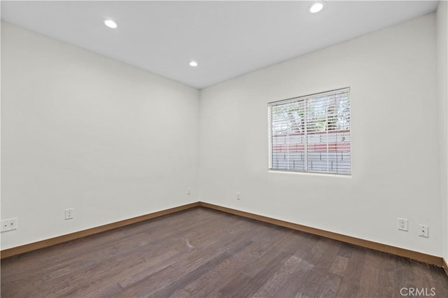 spare room featuring dark hardwood / wood-style flooring