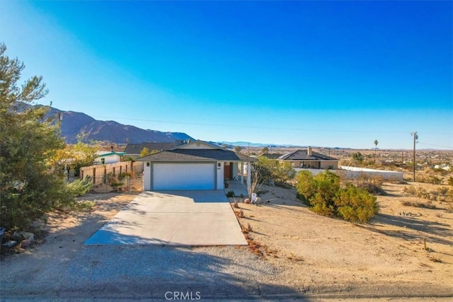 view of front of home with a mountain view and a garage