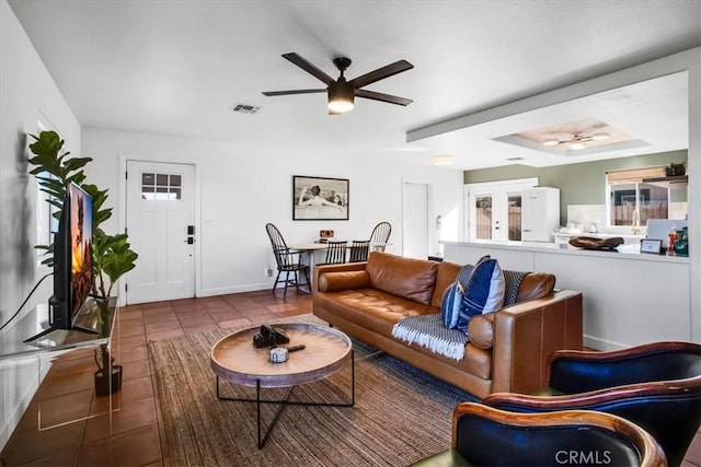 tiled living room featuring ceiling fan