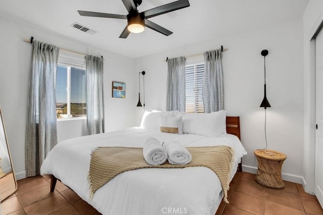 bedroom featuring a closet, tile patterned floors, and ceiling fan