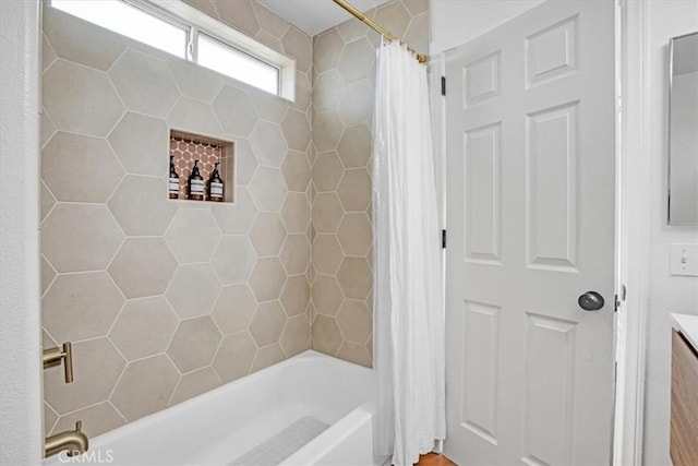 bathroom featuring vanity and shower / bathtub combination with curtain