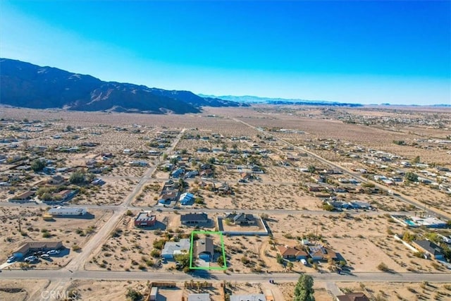 birds eye view of property with a mountain view