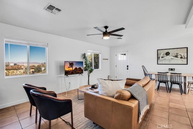 tiled living room featuring ceiling fan