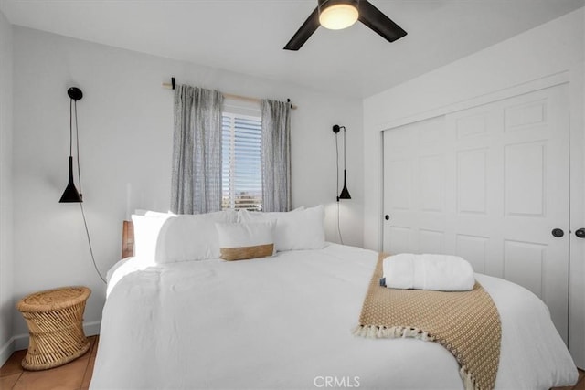 tiled bedroom with a closet and ceiling fan