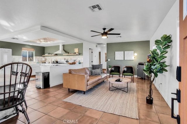 tiled living room with sink and ceiling fan