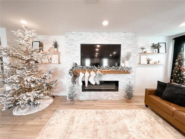 living room with a fireplace and hardwood / wood-style flooring