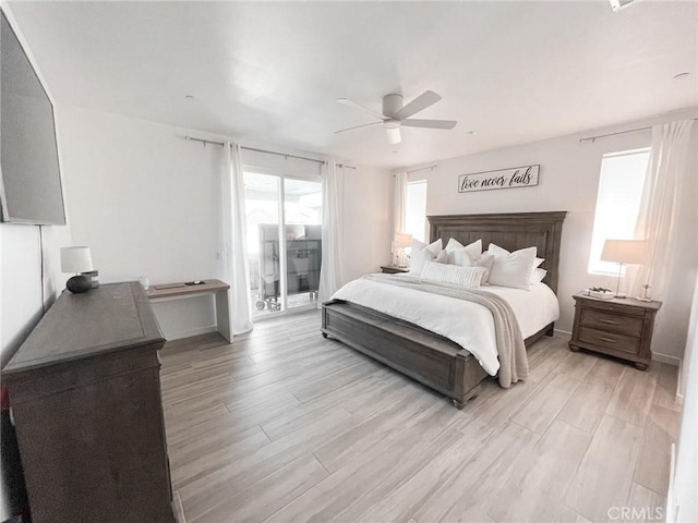 bedroom with light wood-type flooring, ceiling fan, and access to outside