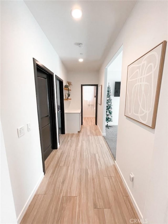 corridor featuring light hardwood / wood-style floors