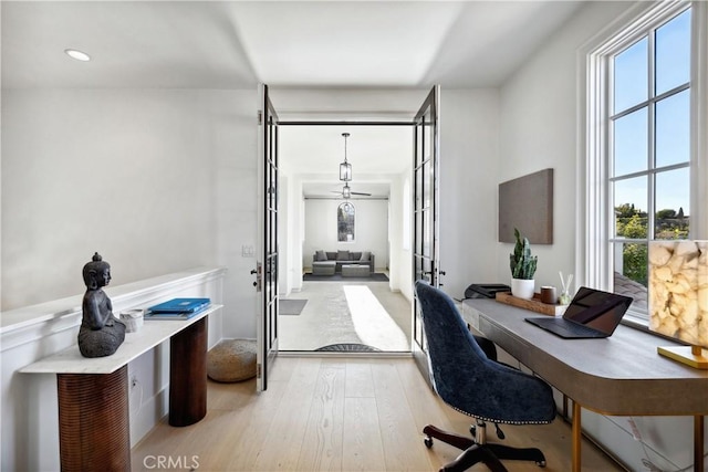 home office featuring light hardwood / wood-style floors and french doors