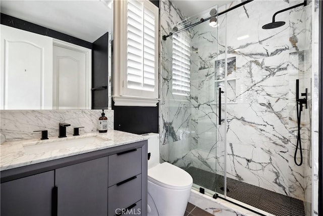 bathroom featuring walk in shower, vanity, and toilet