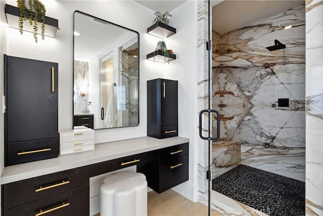 bathroom with vanity, hardwood / wood-style floors, and an enclosed shower