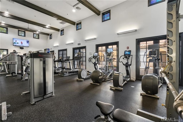 gym with visible vents and a high ceiling