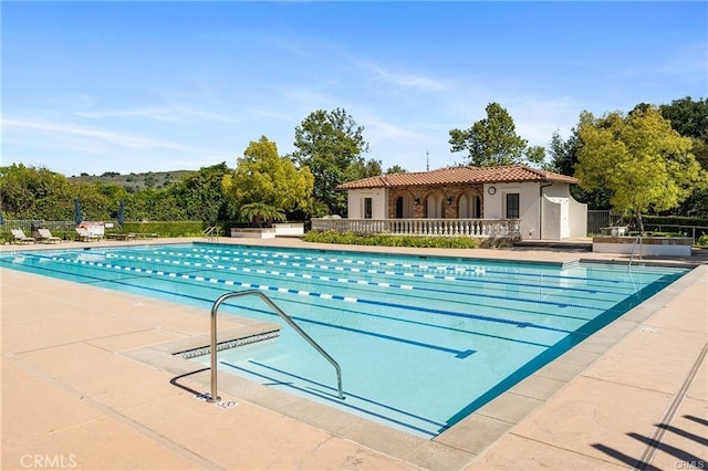 pool featuring a patio and fence