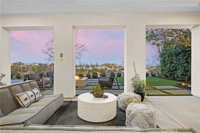 patio terrace at dusk featuring an outdoor hangout area