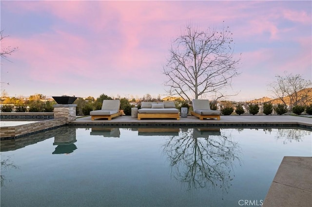 view of pool at dusk